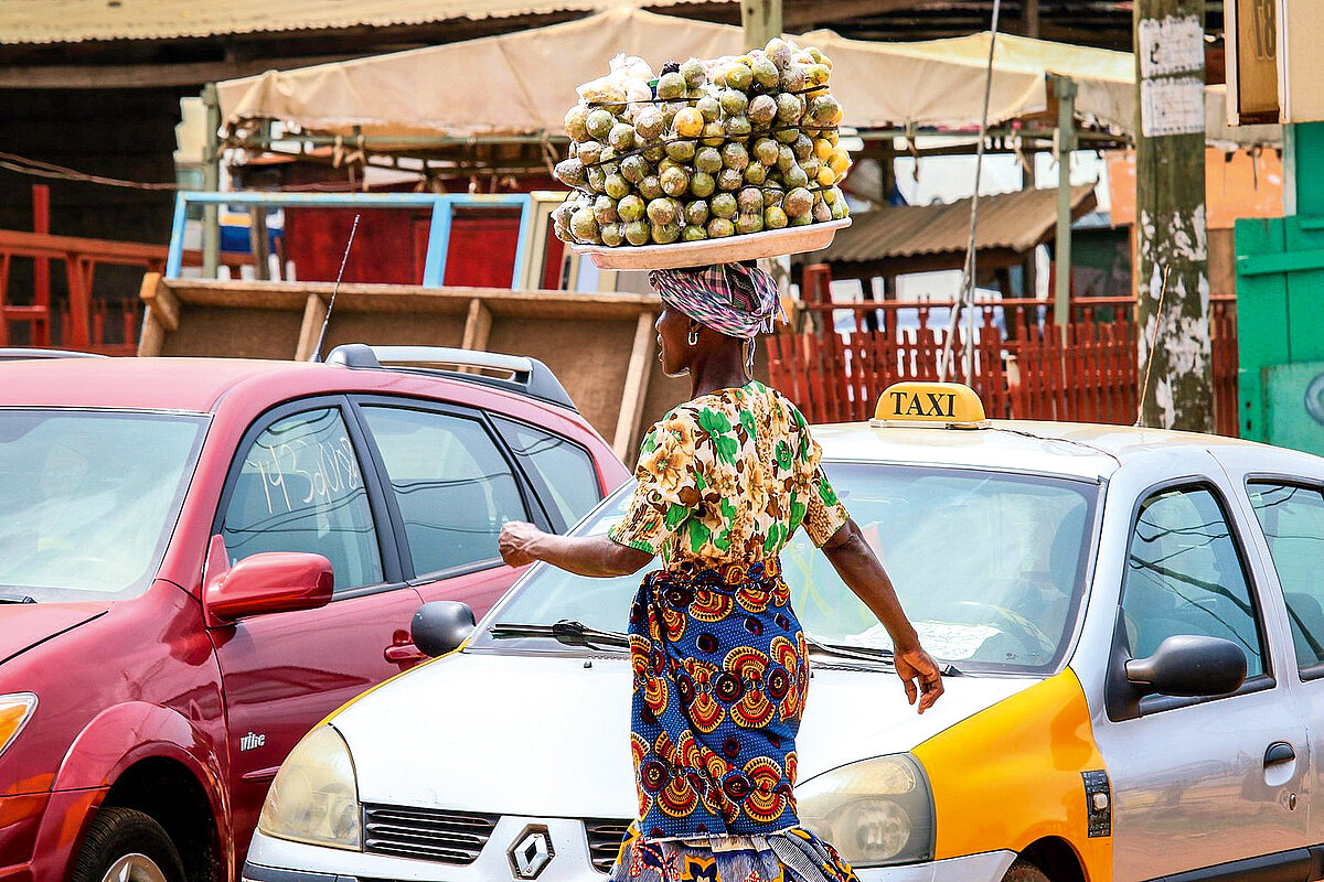 Accra, Ghana - April 06, 2022: Local African Street Woman Seller on the  Accra street
